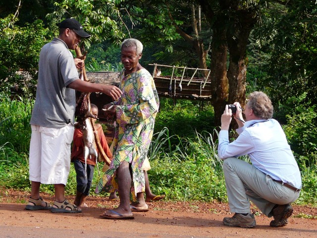 Didier buying bushmeat on the roadside